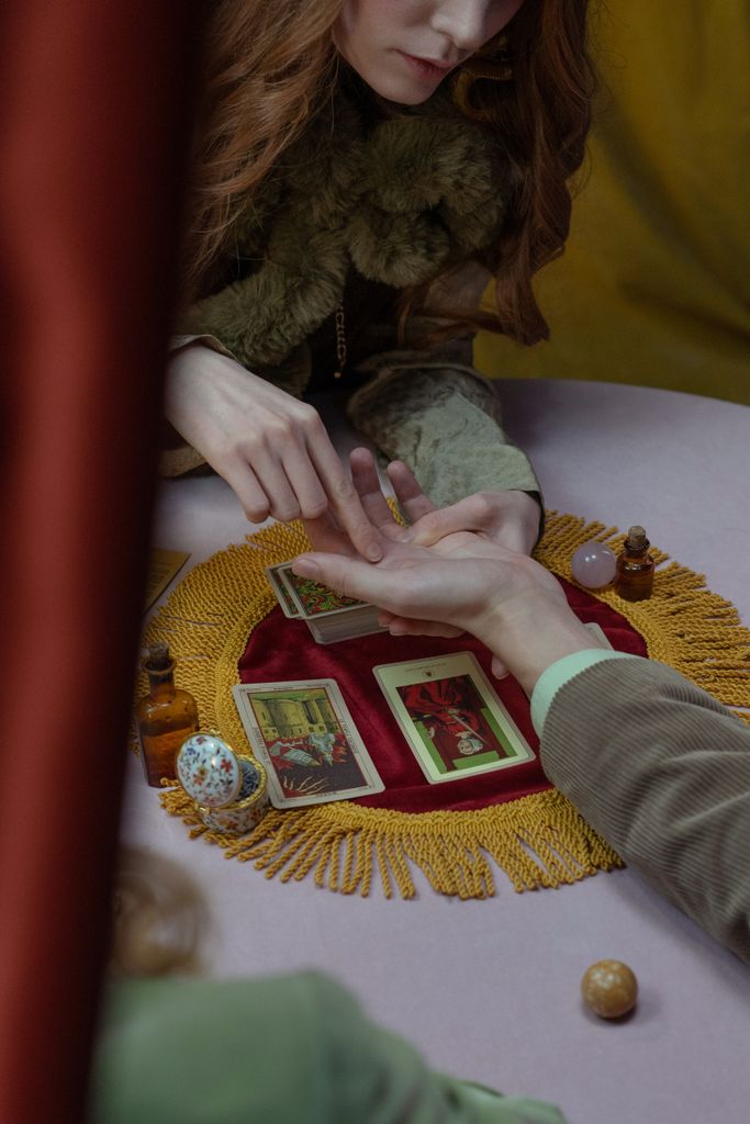 A mystical session with tarot cards and palmistry, exploring fortune and future insights.
